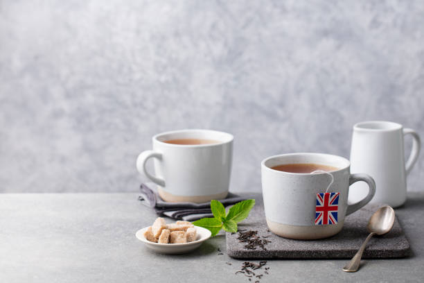 istock Tea in mugs with British flag tea bag label. Grey background. Copy space. 1178069953