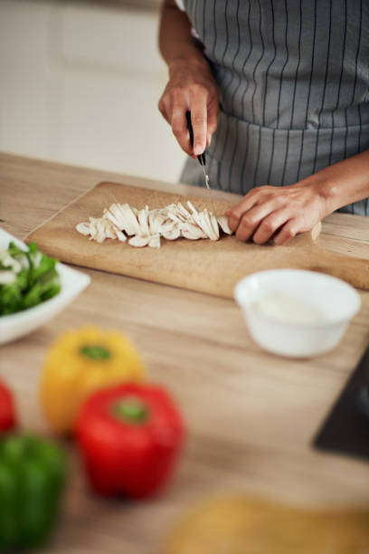 istock Woman cutting mushrooms. 1178070119