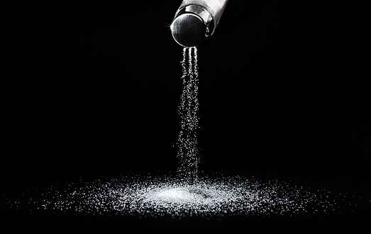Salt shaker on a dark background