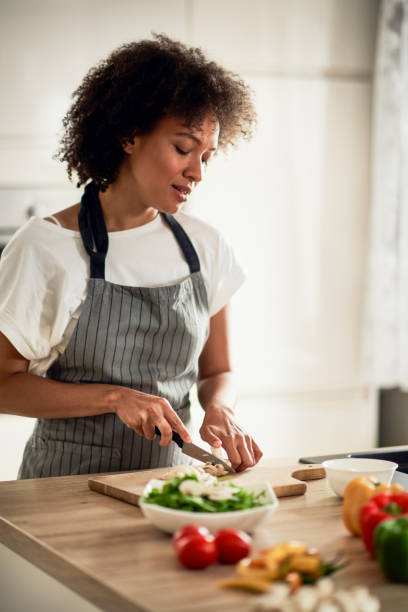 istock Mixed race woman chopping mushrooms. 1178070448