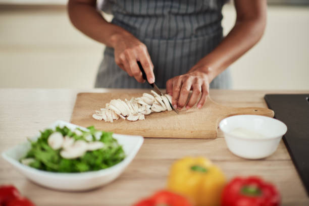 istock Woman cutting mushrooms. 1178070451