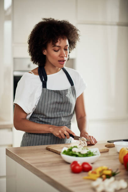 istock Mixed race woman chopping mushrooms. 1178070530