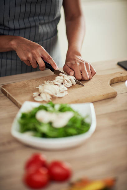 istock Woman cutting mushrooms. 1178070531