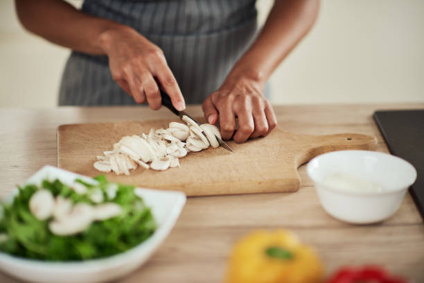 istock Woman cutting mushrooms. 1178070851