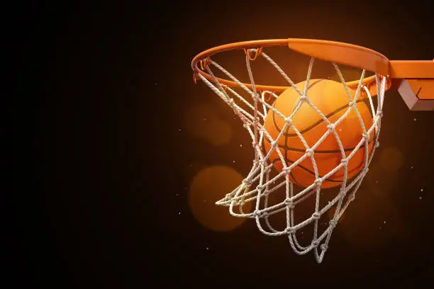 Photo of 3d rendering of a basketball in the net on a dark background.