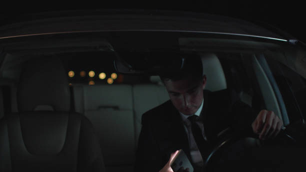 istock Businessman gets in car at night with bag 1178075255