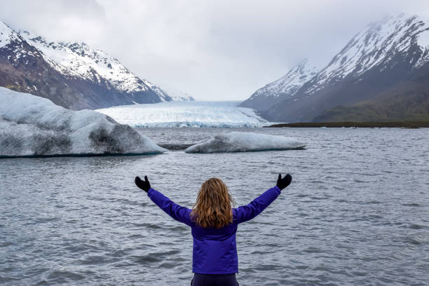 istock Woman looking at mountain range and glacier. 1178077532