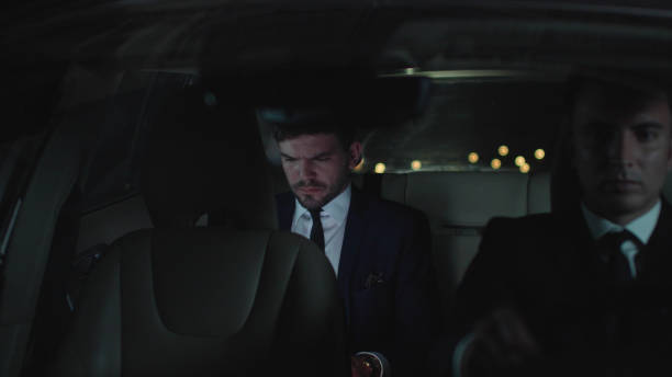 istock Man drive in car with a laptop at night 1178077697