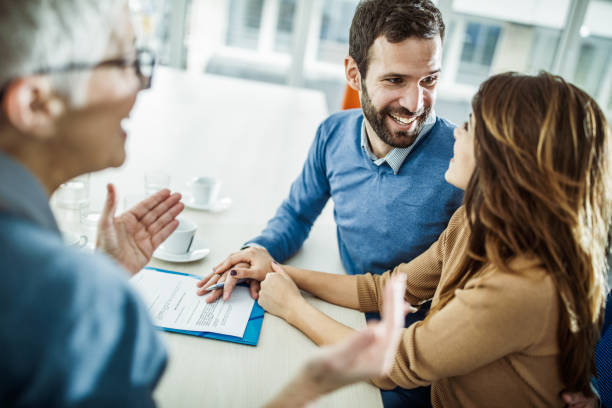 istock Happy couple communicating while having a meeting with insurance agent in the office. 1178085342