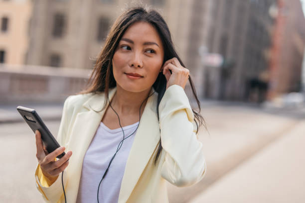 istock Chinese woman using smart phone in the city 1178085359