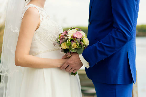 istock the groom gently holds the bride's hands 1178085618