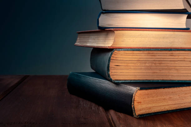 istock A stack of old books against a dark background with copy space, selective focus 1178087503