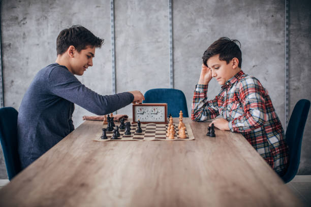 istock Boys playing chess in school of chess 1178090613