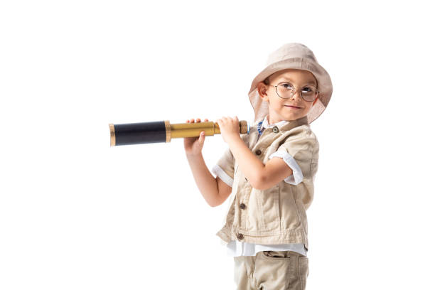 istock smiling explorer boy in glasses and hat holding spyglass isolated on white 1178090810