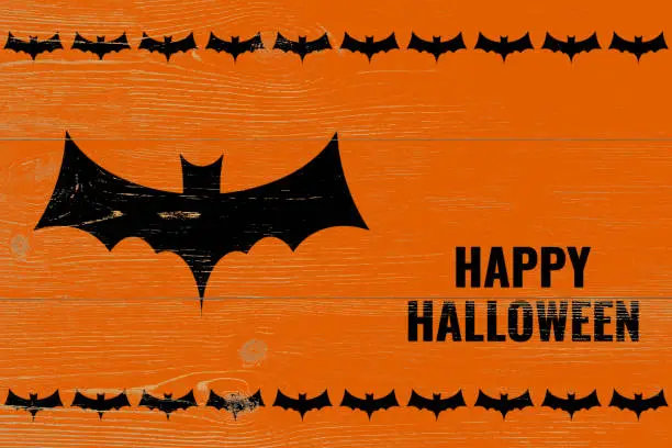 happy halloween greetings with black bat silhouette on orange wooden wall