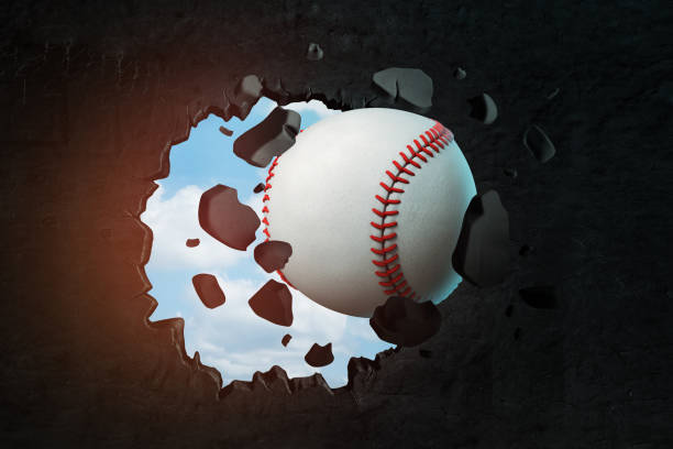 istock 3d rendering of a baseball punching a hole in black wall with blue sky peeking through. 1178092041