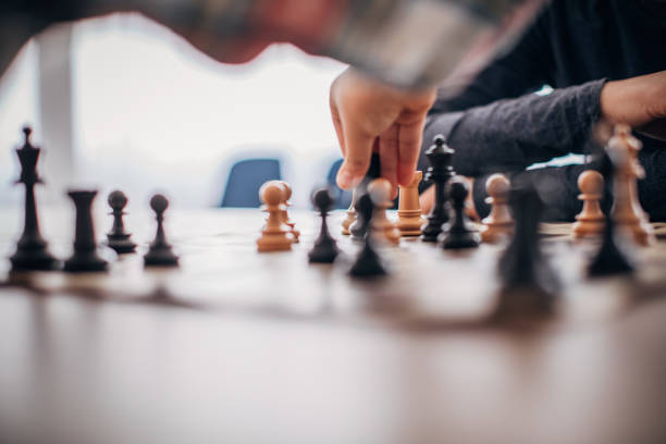 istock Two boys playing a game of chess in chess school 1178092439