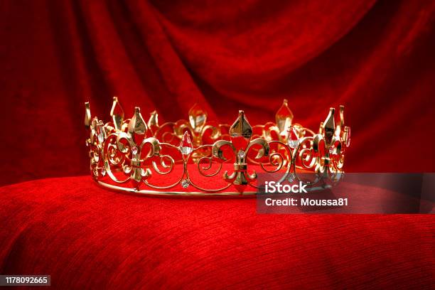 Royalty Monarch Coronation Or Leadership Conceptual Idea With King Gold Crown With Jewels On Red Velvet Pillow Stock Photo - Download Image Now