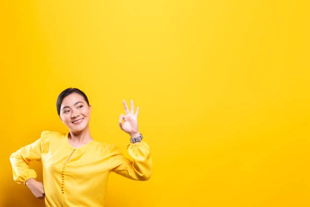 istock Happy woman showing OK gesture isolated on background 1178093689