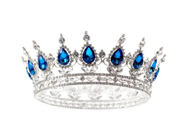 Beauty pageant winner, bride accessory in wedding and royal crown for a queen concept with a silver tiara covered diamonds and blue sapphire stones isolated on white with clip path cut out