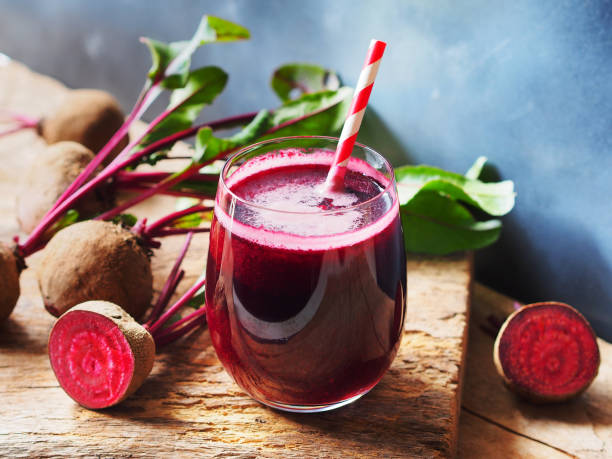 Beetroot juice. Beetroot juice in a glass and fresh organics beetroot on rustic wooden table for refreshing drinks concept. common beet photos stock pictures, royalty-free photos & images
