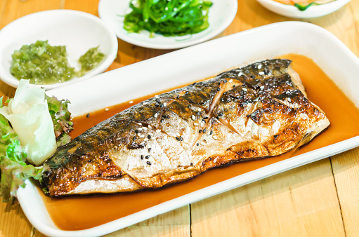 Saba or mackerel fish grilled with soy sauce with black and white sesame on japanese food table.