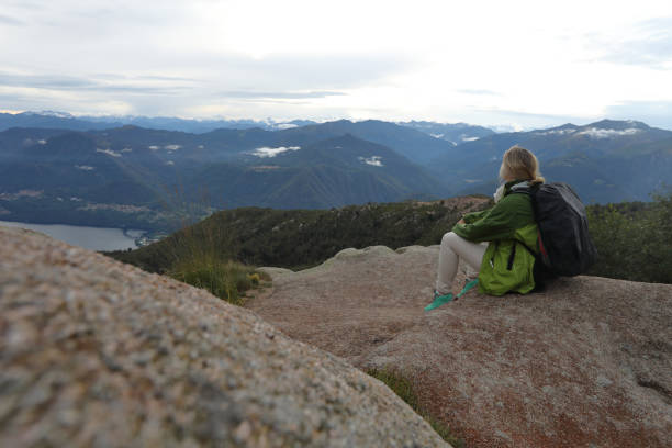 istock Female hiker relaxes by rock features on mountain 1178098365