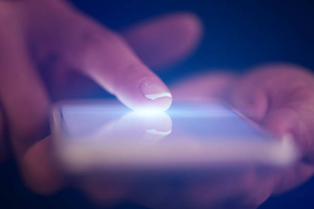 istock Finger touching phone with dark background 1178098735