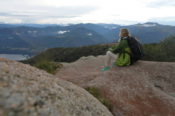 istock Female hiker relaxes by rock features on mountain 1178098962