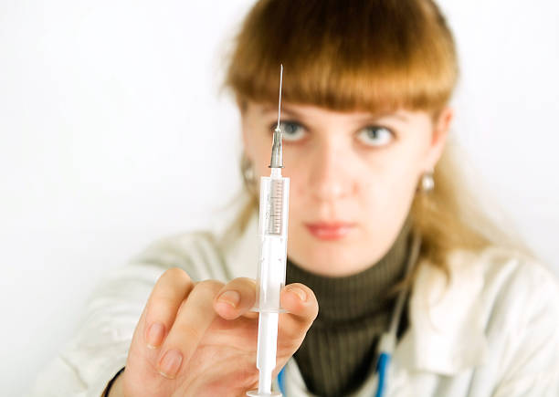 nurse holding the syringe stock photo