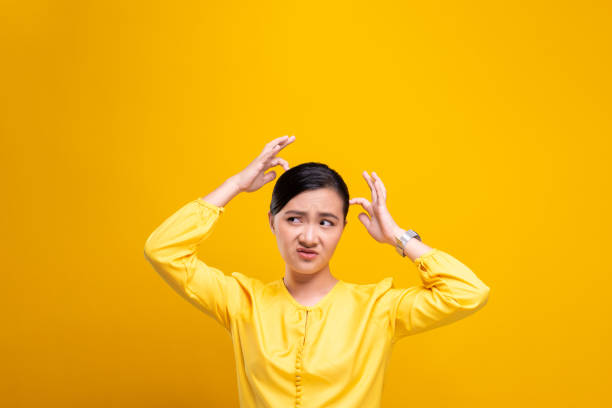 istock Woman scratching her head isolated over yellow background 1178100799