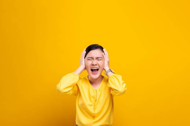 istock Angry woman screaming isolated over yellow background 1178101143