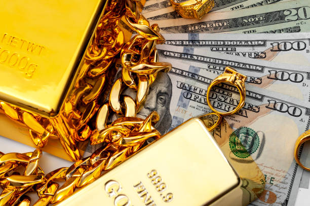 jewelry buyer, pawn shop and buy and sell precious metals concept theme with a pile of cash in us dollars, golden rings, necklace bracelet and gold bullion isolated on white background - jewelry paper currency gold currency imagens e fotografias de stock