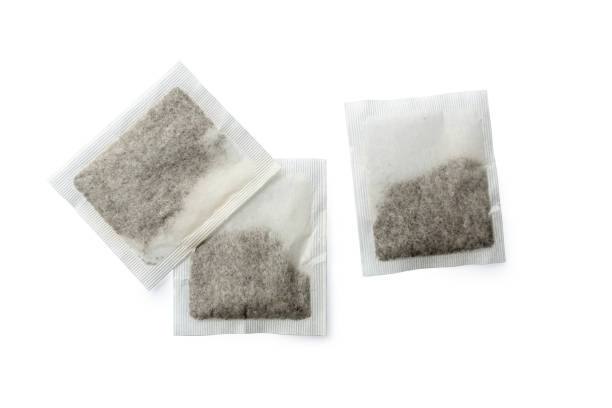 close-up of the group of tea bags isolated on white background - teabag label blank isolated imagens e fotografias de stock