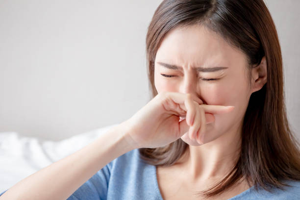 woman has running nose asian woman sick and sneeze in the bedroom bed of hay stock pictures, royalty-free photos & images