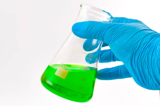 istock Biotech analysis, lab research and analyze pharmaceutical solution conceptual idea with doctor or researcher hand wearing protective latex gloves and analyzing green fluid in science beaker 1178104248