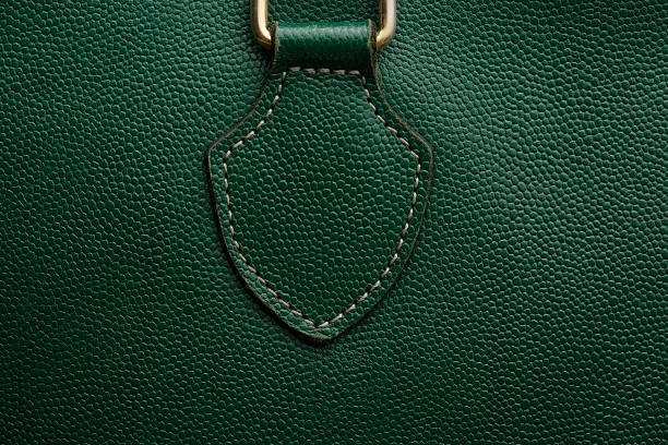 Close-up of a green leather bag texture background Close-up of a green bag leather texture with slight vignette. buckle photos stock pictures, royalty-free photos & images