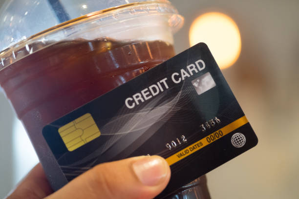 istock Paying for iced coffee by credit card with blur light background 1178106590