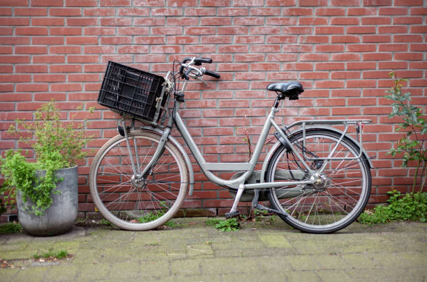 istock Retro bicycle with a basket and old brick wall 1178107595