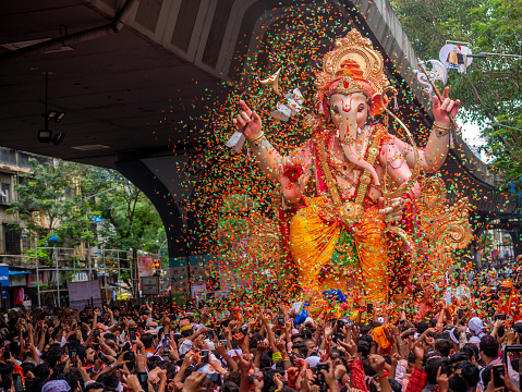 Mumbai, India - September 12,2019 : Thousands of devotees bid adieu to tallest Lord Ganesha with colors in Mumbai during Ganesh Visarjan which marks the end of the ten-day-long Ganesh Chaturthi festival.