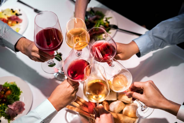mani ritagliate di dirigenti che brindano ai bicchieri da vino - dining table people foods and drinks restaurant foto e immagini stock