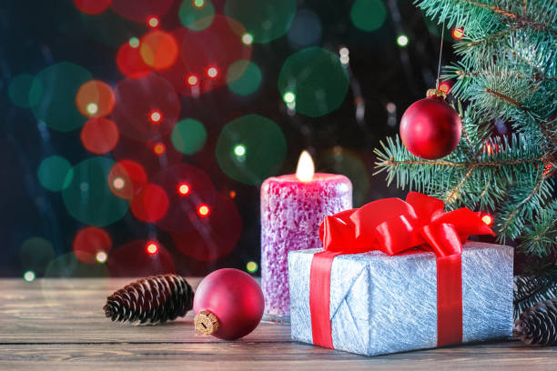 istock Christmas gift, candle and  xmas tree on bokeh background with place for text. 1178119413