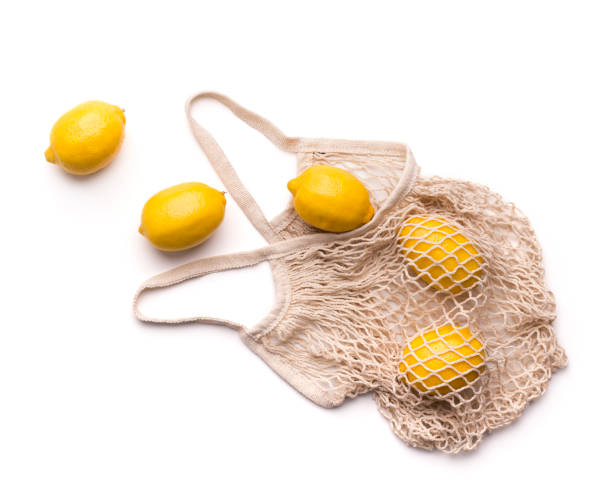 istock Fresh lemons inside eco bag isolated on white background 1178120743