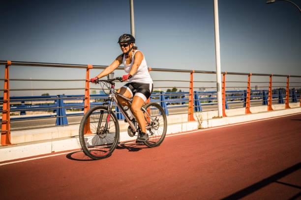 istock Healthy lifestyle: mature woman riding bycicle 1178121684