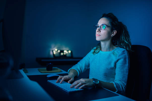 istock Beautiful female student studying at night and typing on wireless computer keyboard. 1178122373