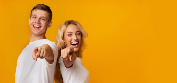 istock Happy millennial couple pointing at camera and laughing 1178122414
