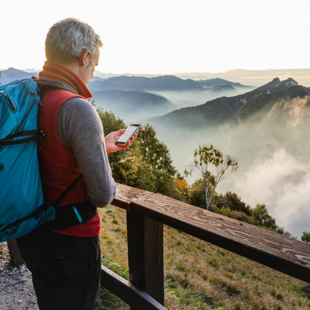 istock Hiker Checking Mountain App With Smartphone 1178122785