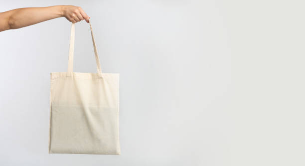 istock Female Hand Holding White Tote Bag, Studio Background, Panorama 1178122890