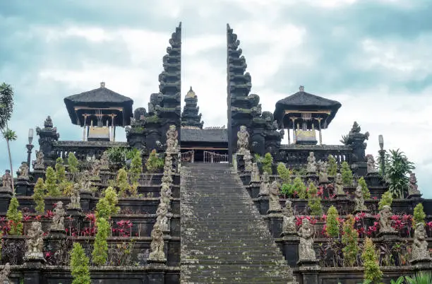 Stairs to Pura Agung Besakih temple by blue sky. Summer landscape with religious building pura basuki puseh jagat on Bali, Indonesia