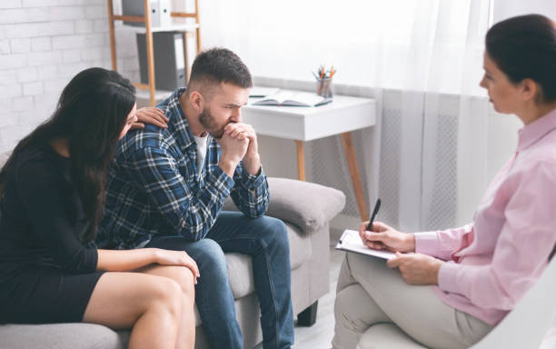 istock Caring wife comforting her stressed husband at psychological session 1178123842